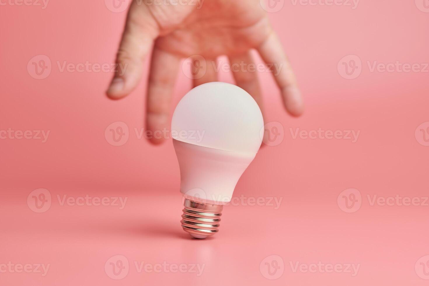 Light bulb and hand, idea catching concept. Symbol of new events or finding solutions to problems. Creative minimal innovations. photo