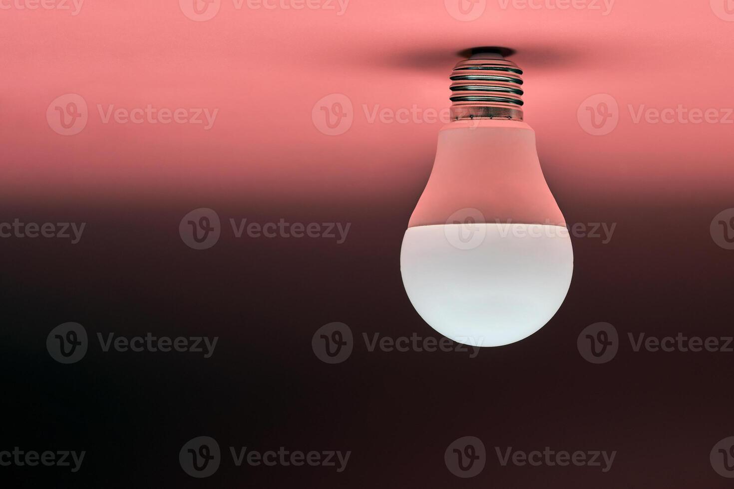 Energy saving light bulb, copy space, pink background. Minimal idea concept. photo