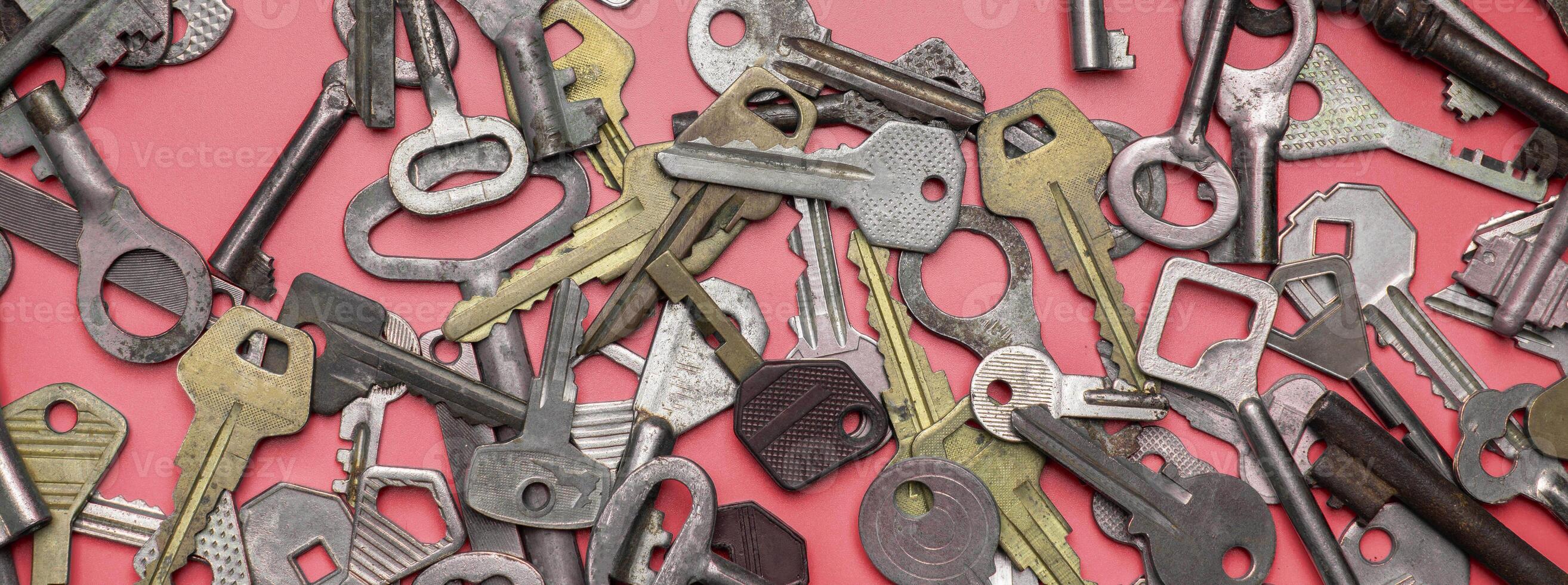Keys set on pink background. Door lock keys and safes for proper photo