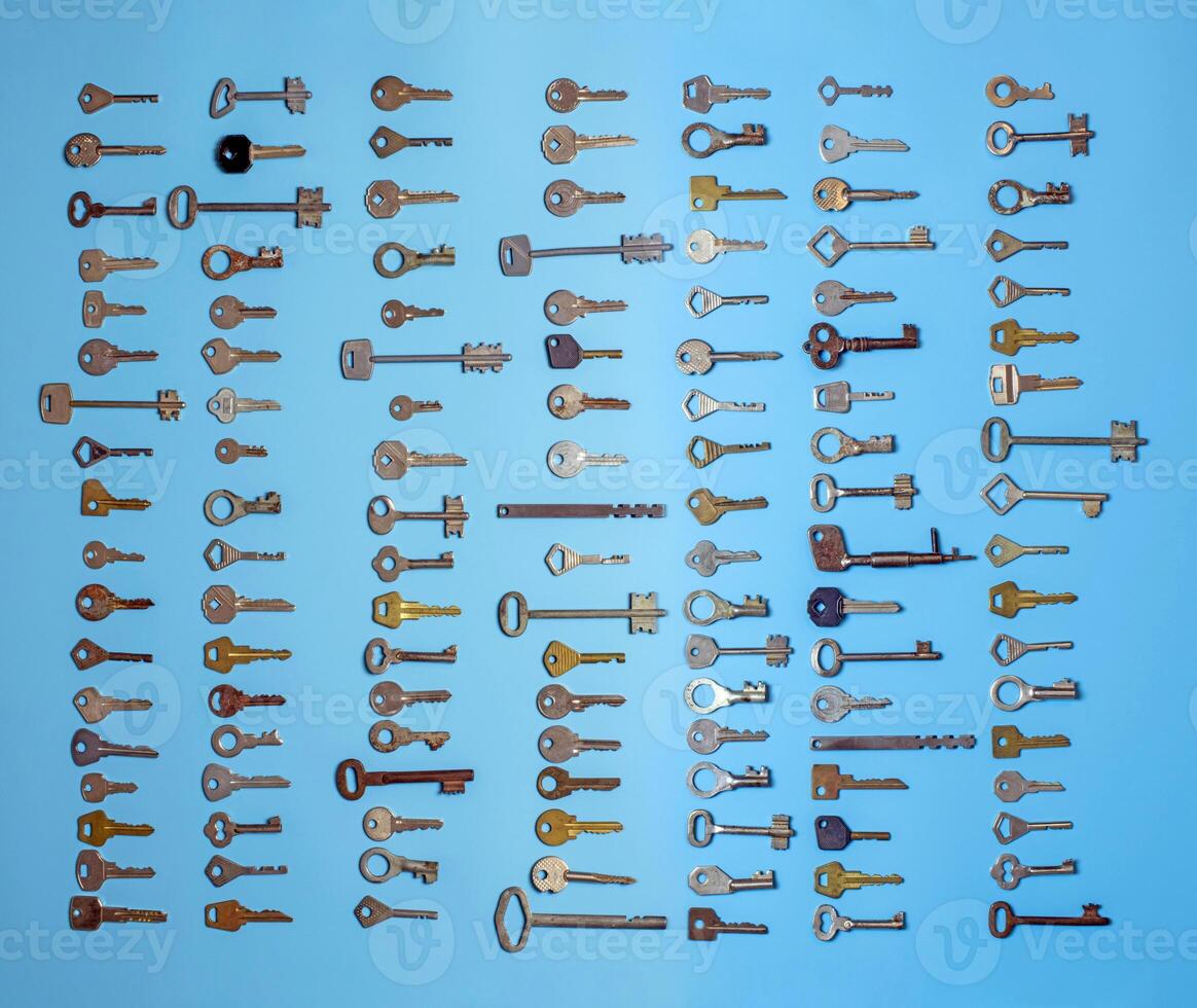 Keys set on blue background. Door lock keys and safes for property security and house protection. Different antique and new types of keys. photo