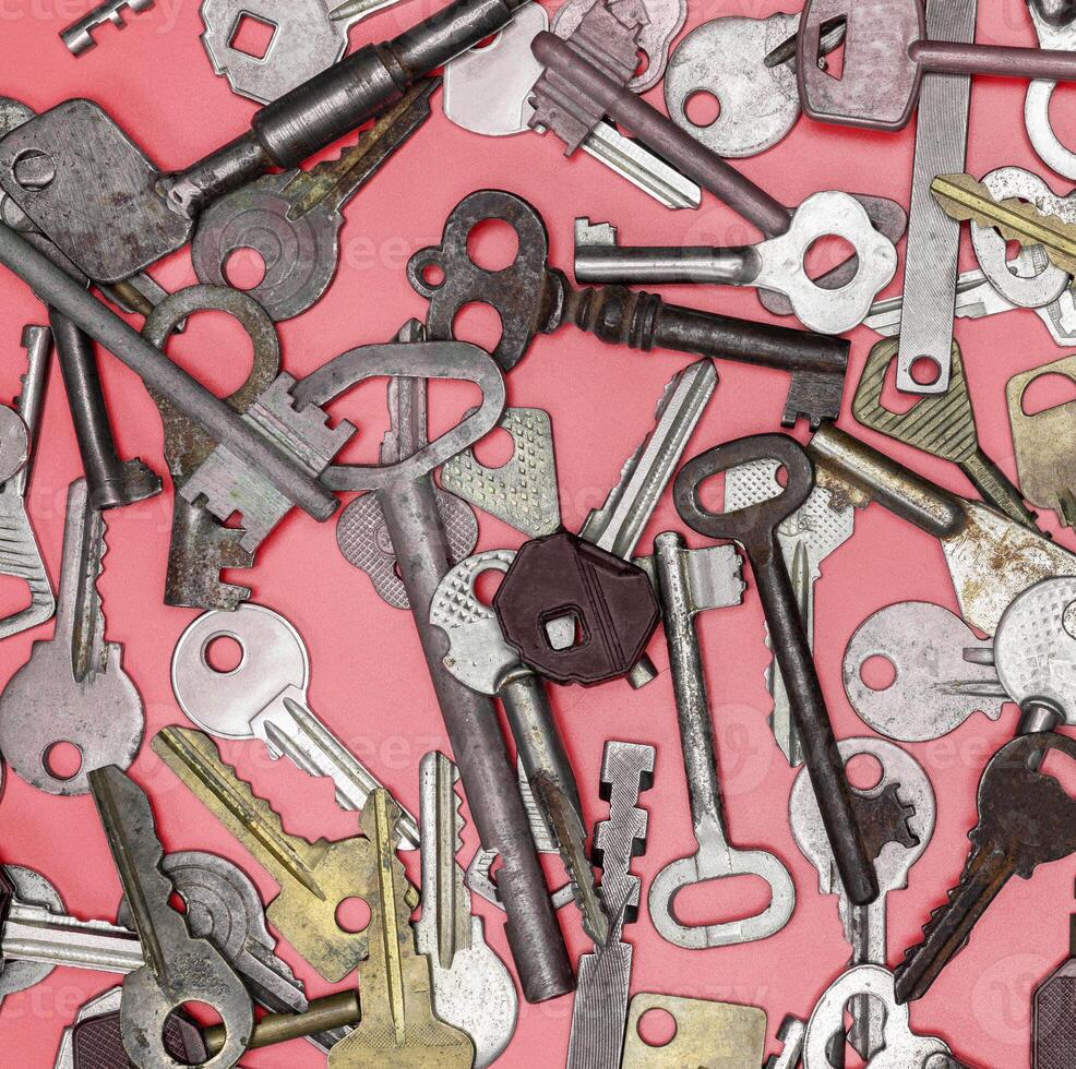 Keys set on pink background. Door lock keys and safes for proper photo