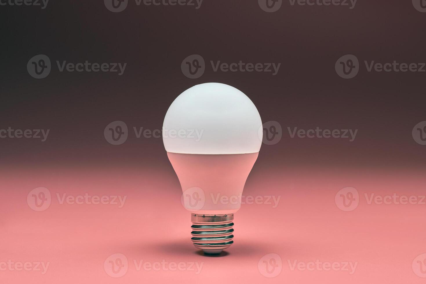 Light bulb, copy space. Energy saving minimal idea concept.Pink background. photo