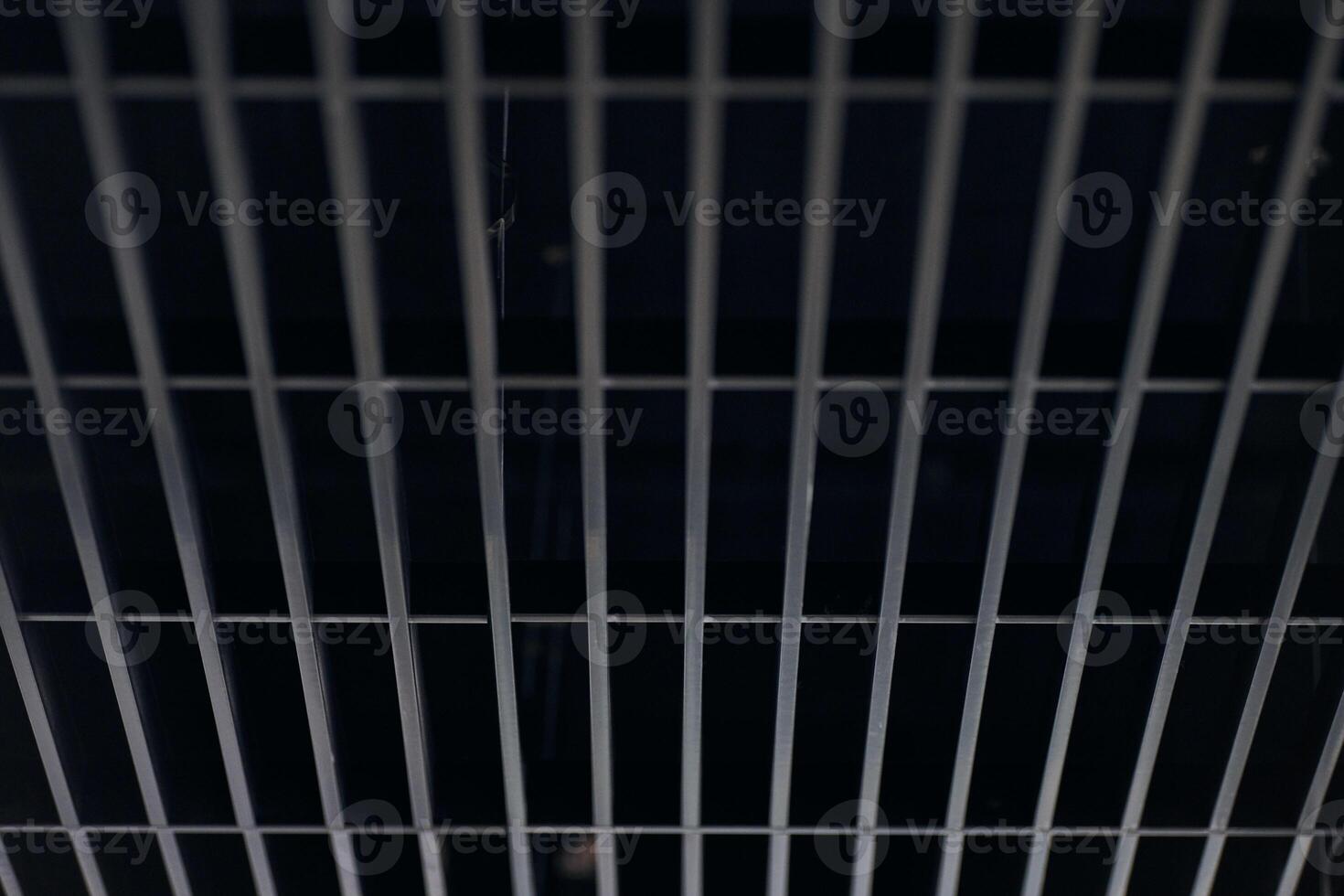 Office grille ceiling. Modern black metal grille ceiling, suspended covering. Abstract design texture. photo