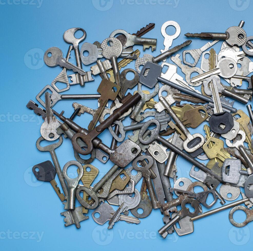 Keys set on blue background. Door lock keys and safes for property security and house protection. Different antique and new types of keys. photo