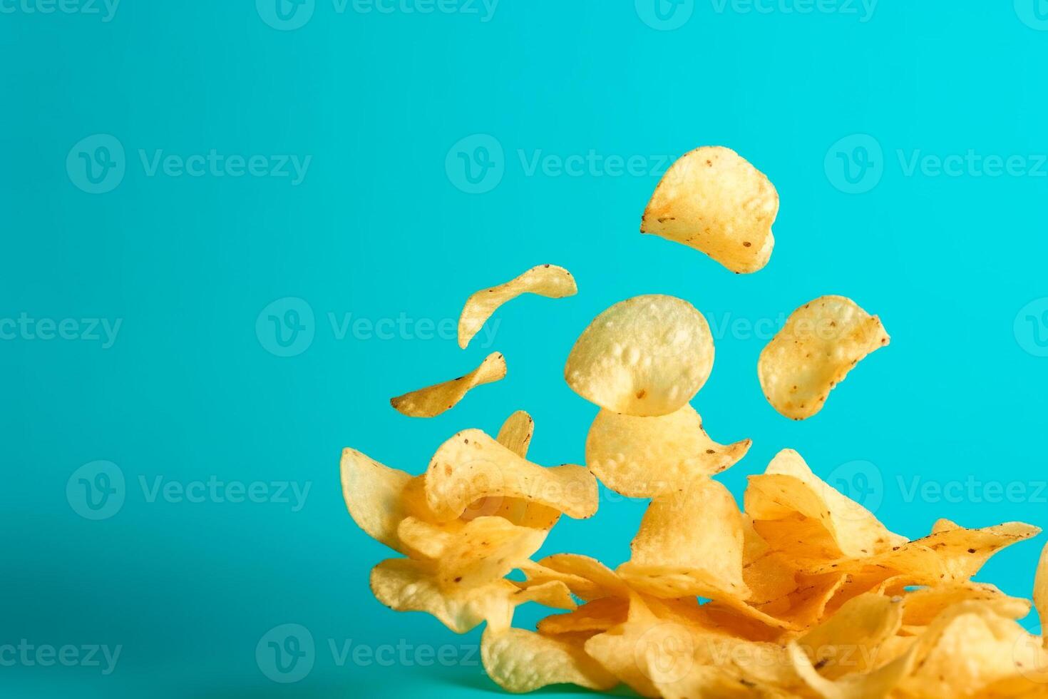 AI generated Potato chips close-up on a blue background, levitation, flight photo