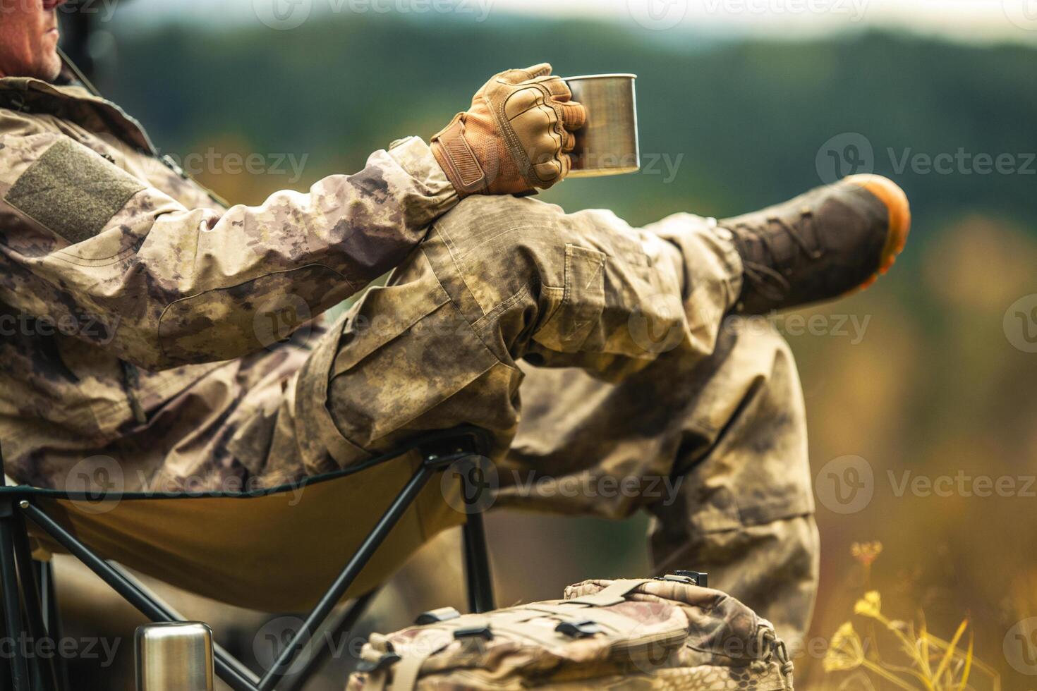 A Hunter Relaxing During Hunting Trip Drinking Coffee Close Up photo