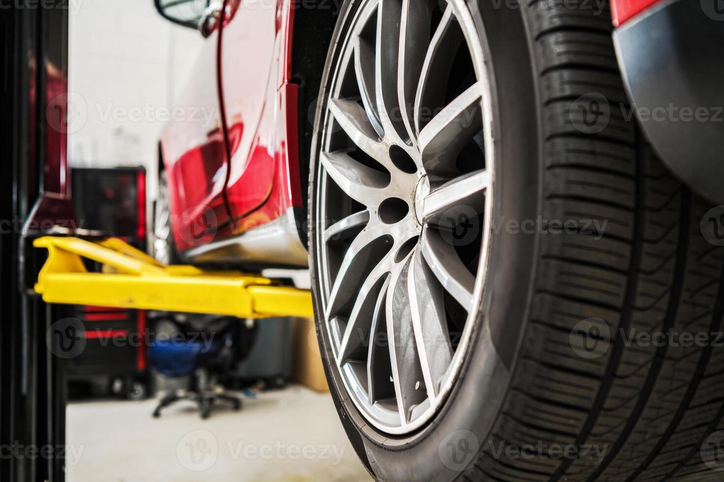 Modern Car on a Auto Service Lift Being Repaired photo