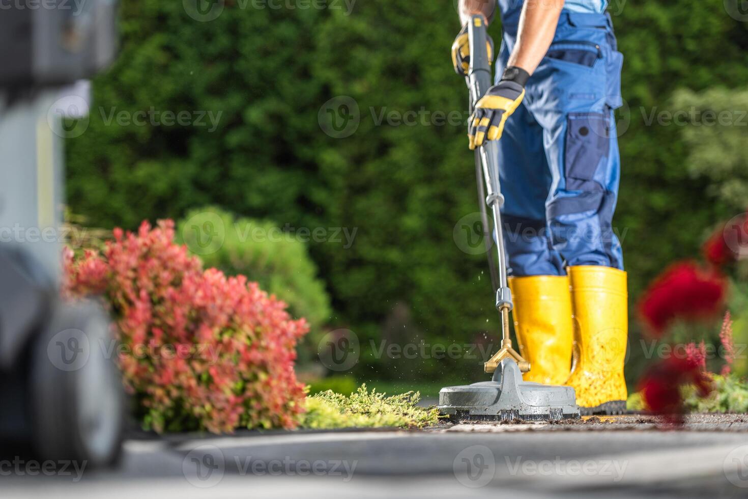 Man Pressure Washing Residential Driveway photo