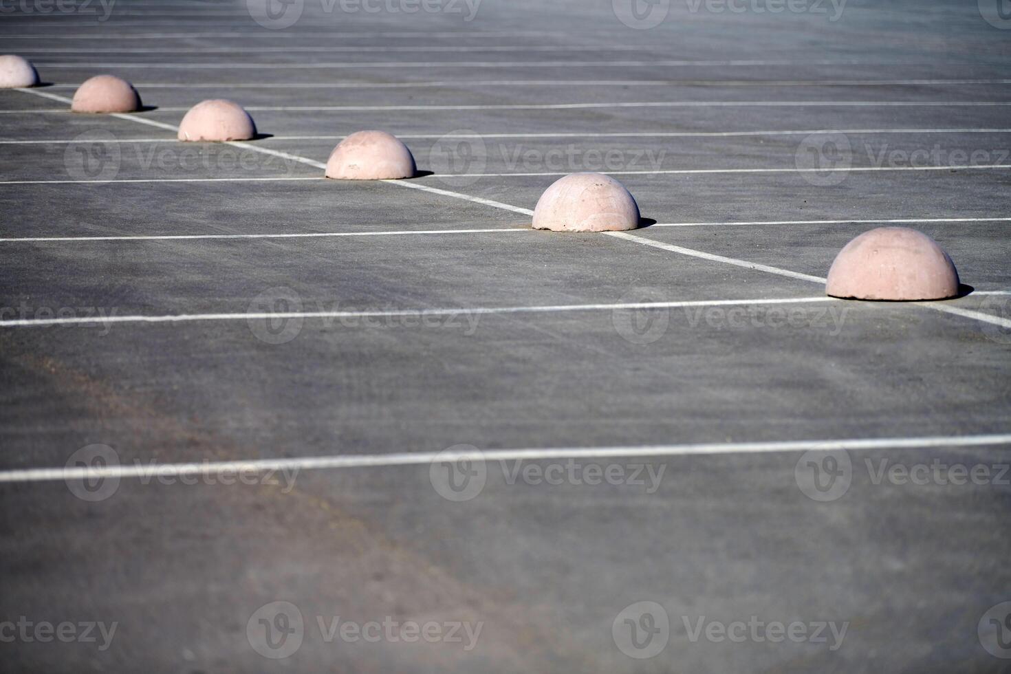 Concrete hemispheres parking limiter. Protection from car parking. Elements to restrict access to parking zone and control movement of vehicles photo