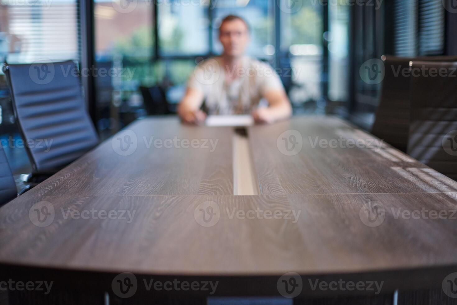 Employee in office conference room. Manager at table in modern meeting room for business negotiations and business meetings. Interview with a new employee. photo