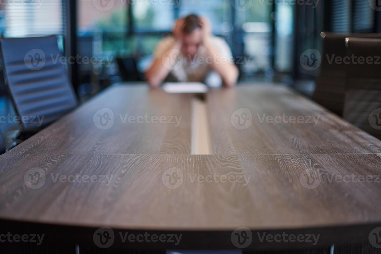 Fired employee in conference room. Manager at table in modern meeting room for business negotiations and business meetings. photo