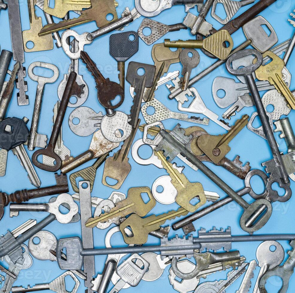 Keys set on blue background. Door lock keys and safes for property security and house protection. Different antique and new types of keys. photo