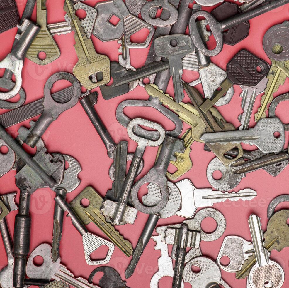Keys set on pink background. Door lock keys and safes for proper photo