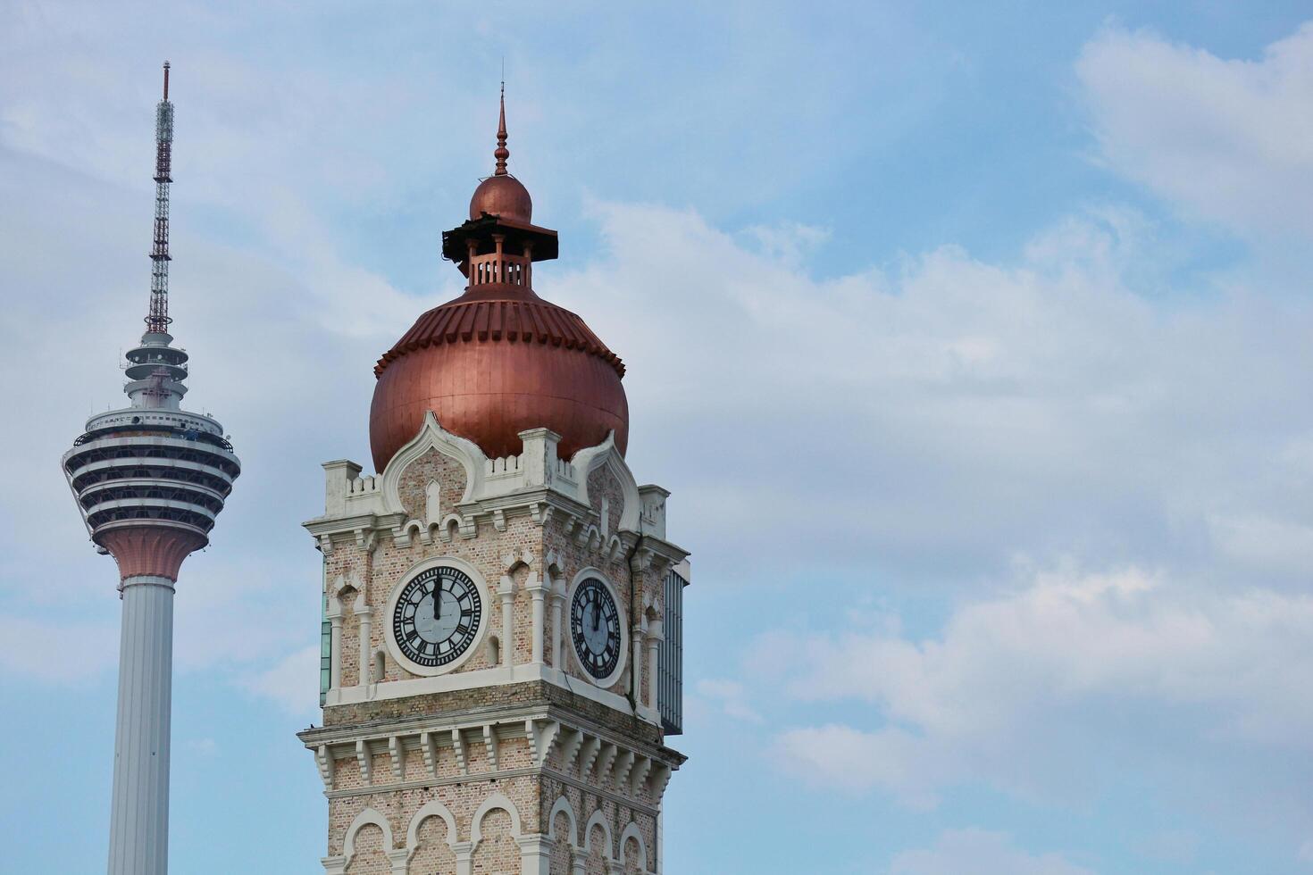 Kuala Lumpur, Malaysia on May 22, 2023. Close up of the clock tower, Big Ben Malaysia. Seen the Kuala Lumpur Tower. Near Masjid Jamek station. photo