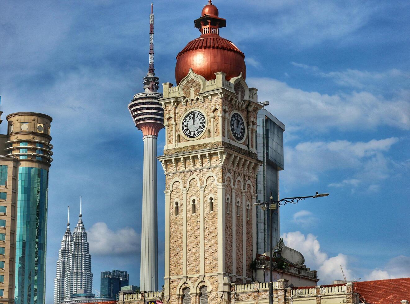 Kuala Lumpur, Malaysia on May 22, 2023. Close up of the clock tower, Big Ben Malaysia. Seen the Kuala Lumpur Tower. Near Masjid Jamek station. photo