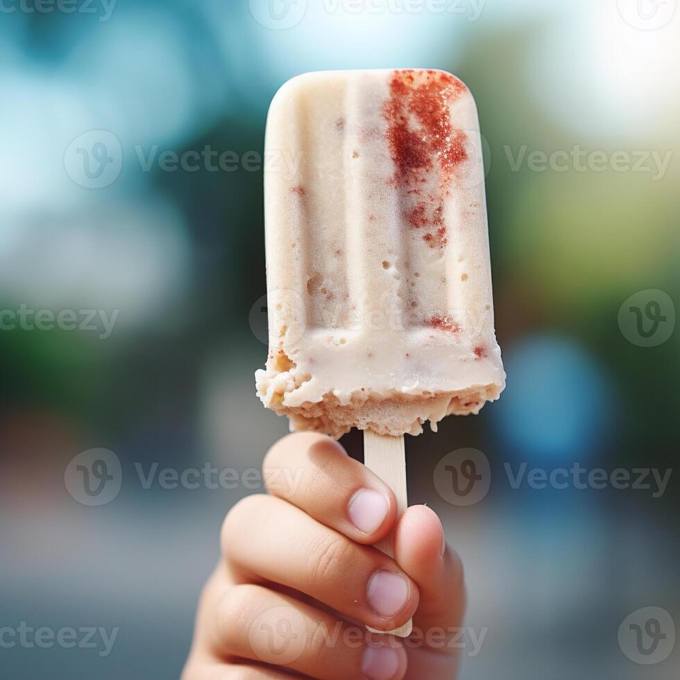 AI generated A child holds a popsicle on a stick. Close-up. Fruity summer refreshing snack photo