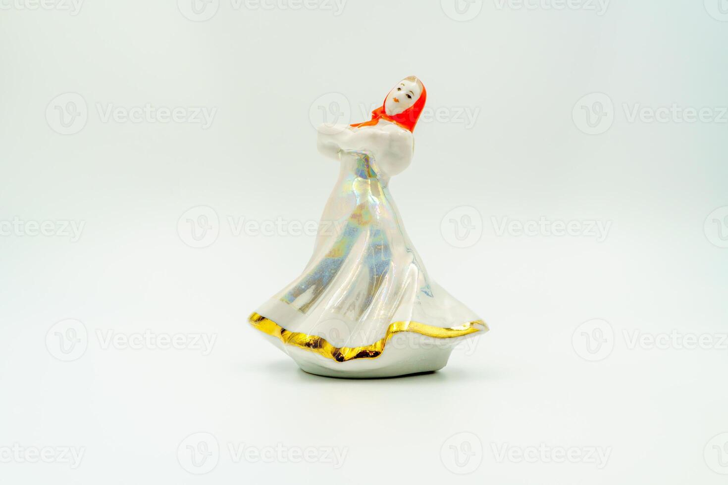 Porcelain Ceramic lady figurine, elegant gown, draped scarf, reflective sheen, crafted finish. Traditional attire, bright trousers, waist sash, green rounded base, folk hand-painted. White background photo