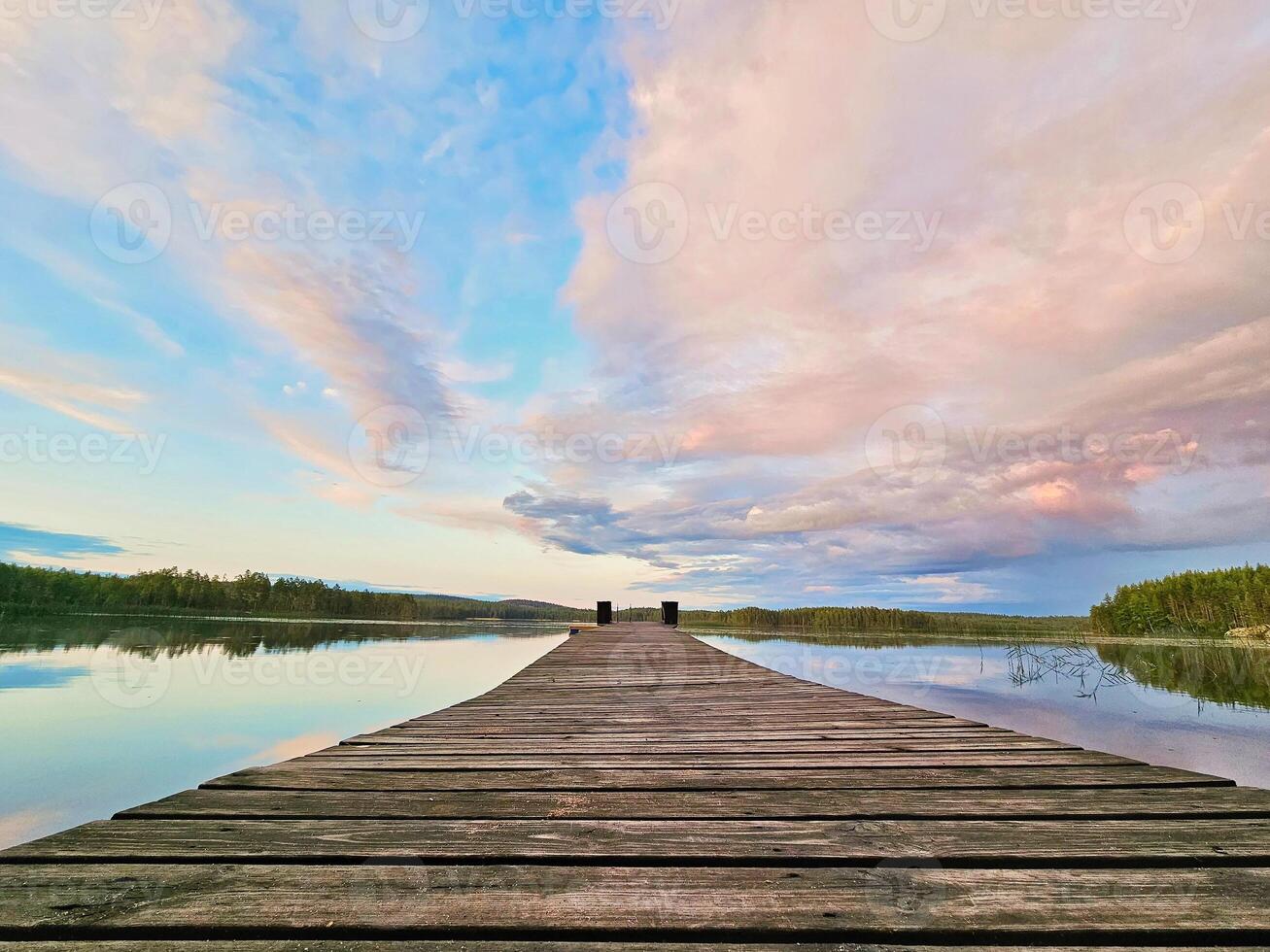 Wooden jetty jutting into a Swedish lake. Nature shot from the Scandinavian photo