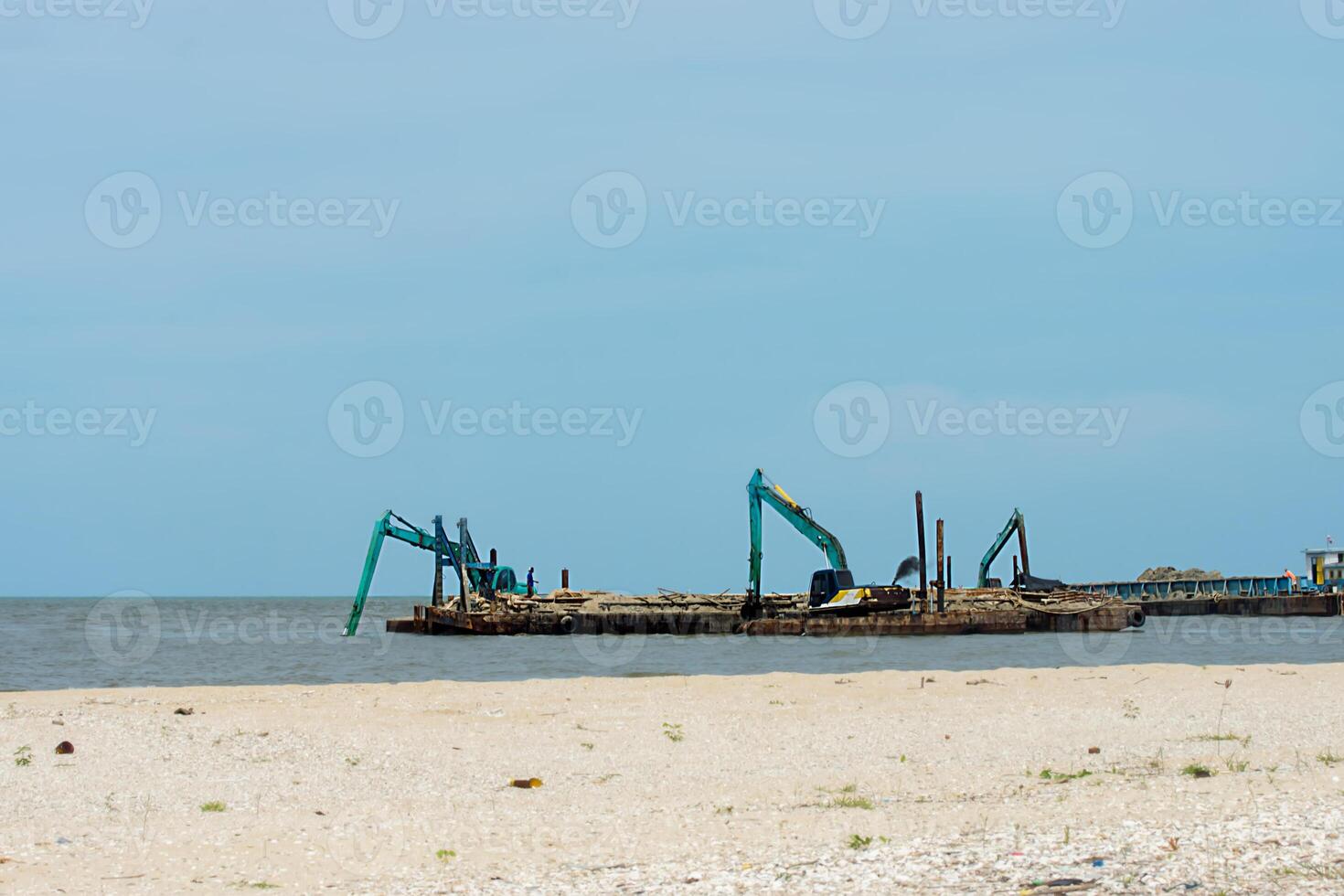 Machines are dredging sand in the sea. photo