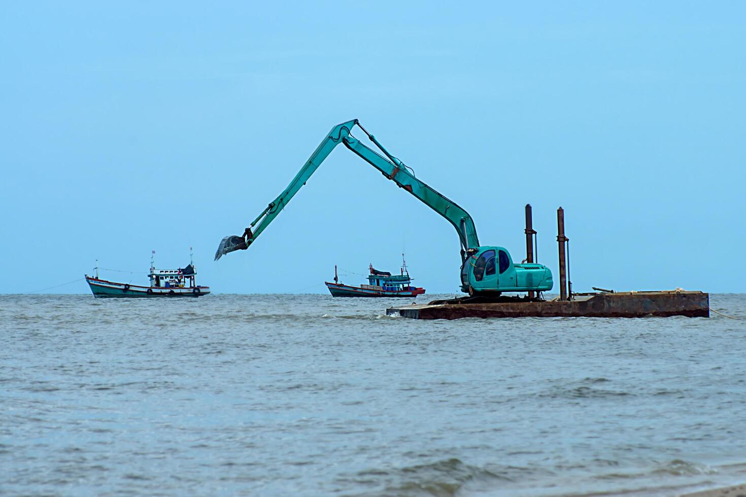 Machines are dredging sand in the sea. photo