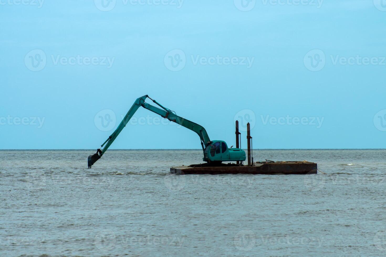 Machines are dredging sand in the sea. photo