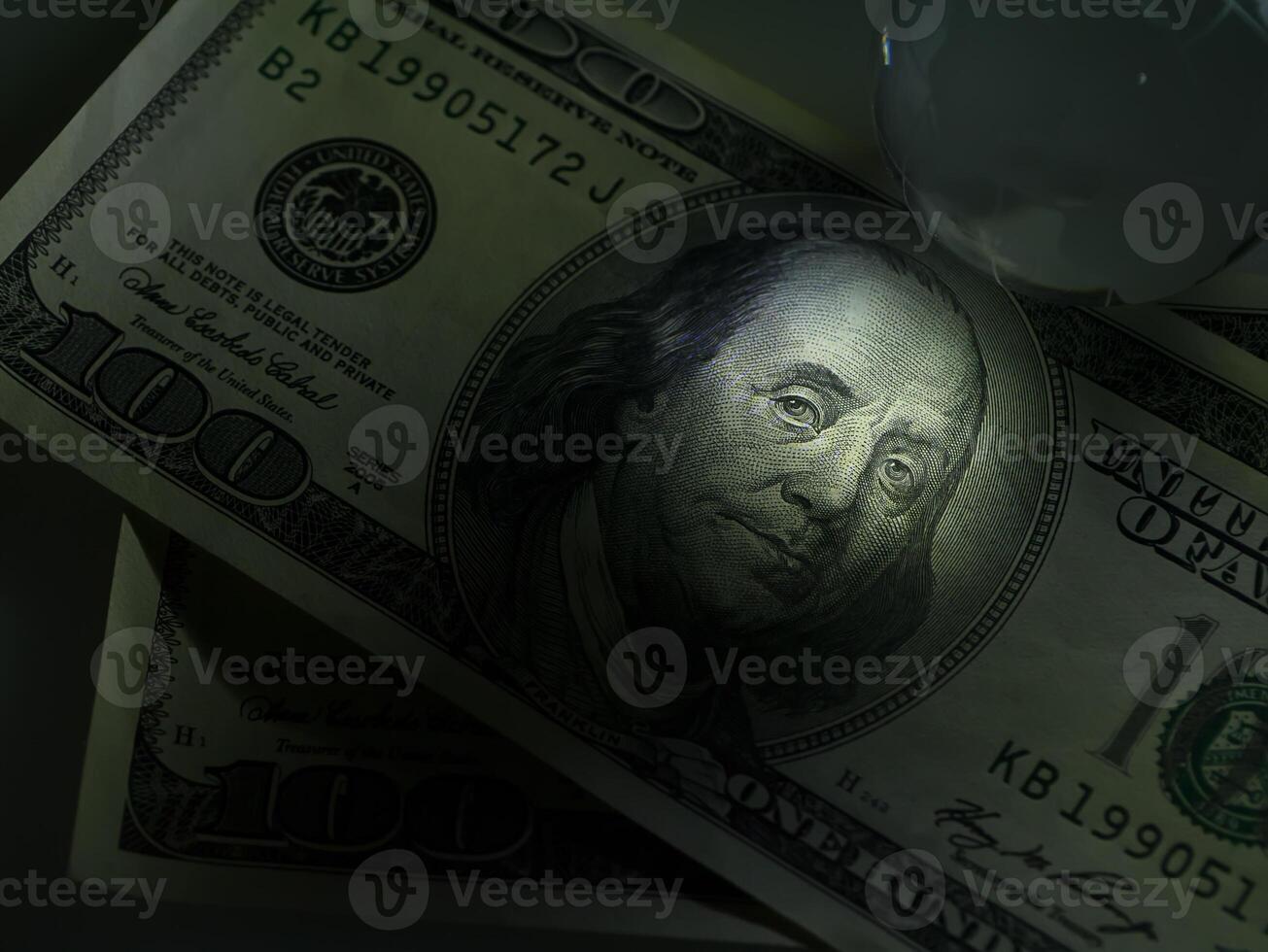 Low key image close up of face on dollar photo