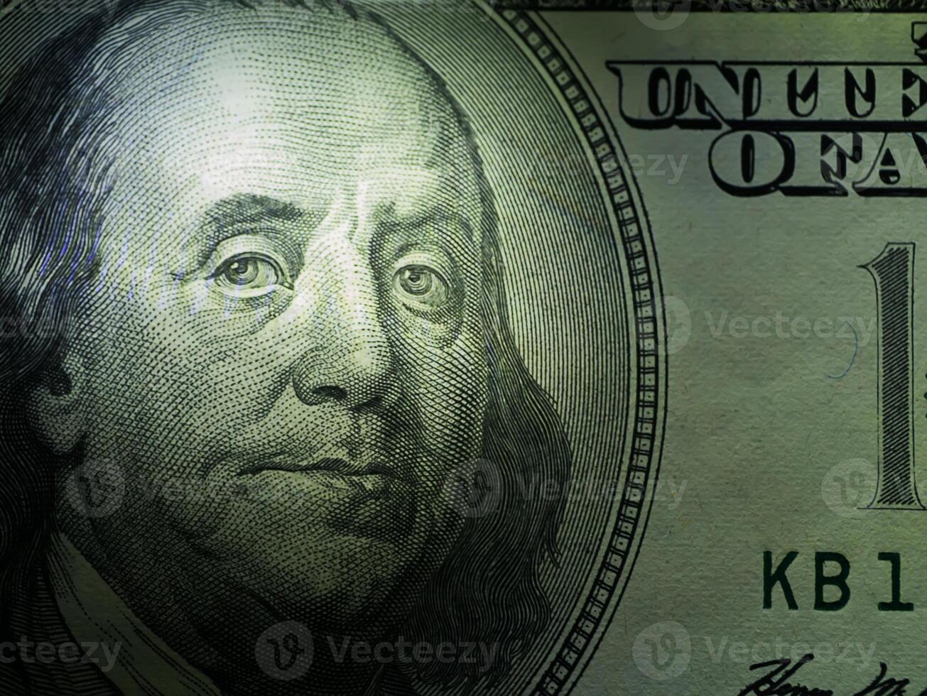 Low key image close up of face on dollar photo