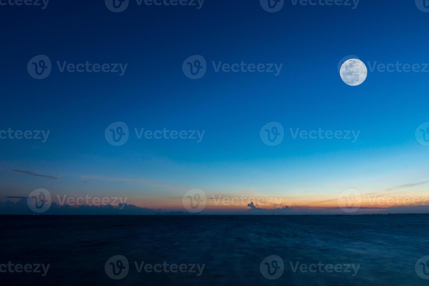Fullmoon on sky at the lake in the twilight. photo
