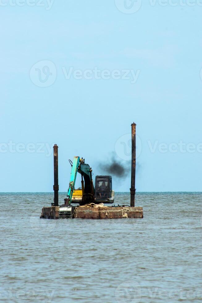 Machines are dredging sand in the sea. photo