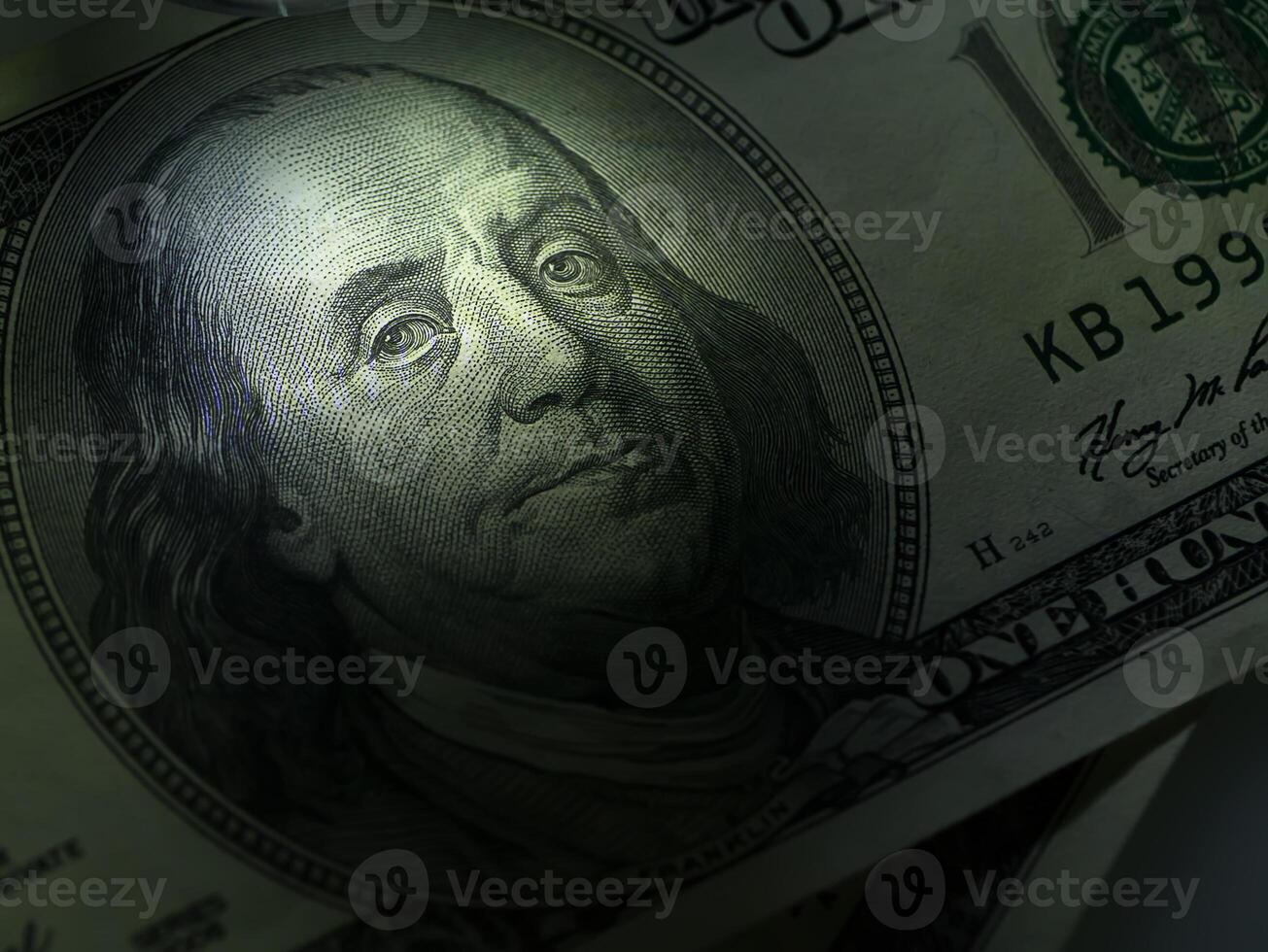 Low key image close up of face on dollar photo