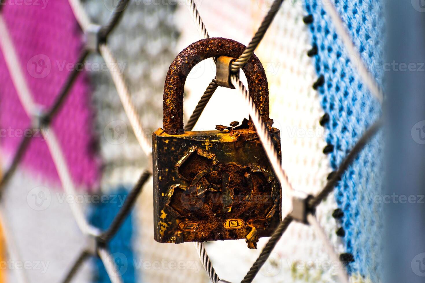 Rusty padlocks attached to the metal railing of a bridge, tradition of padlocks, symbol of eternal love photo