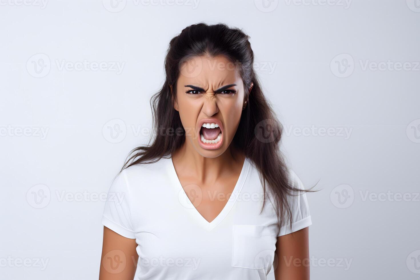 AI generated Angry young adult Latin American woman yelling on grey background. Neural network generated photorealistic image. photo