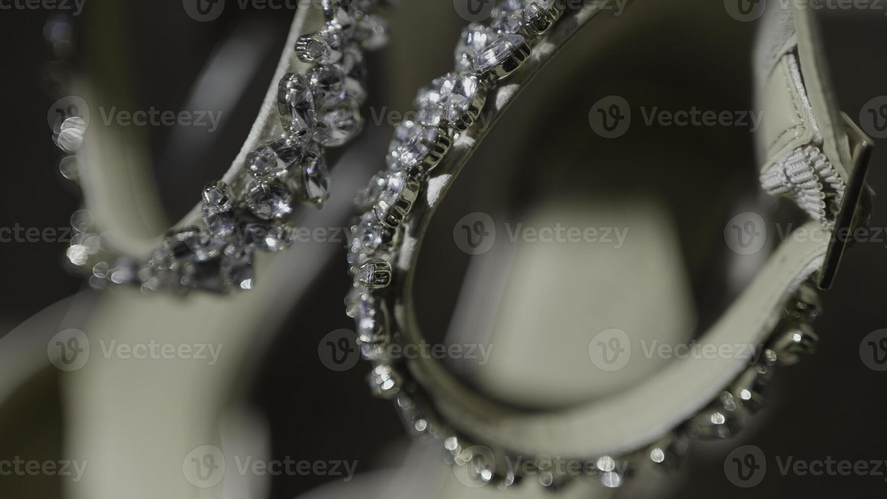 Elegant ceremony shoes, bridal sandals with rhinestones. Action. Close up of female new beige shoes. photo