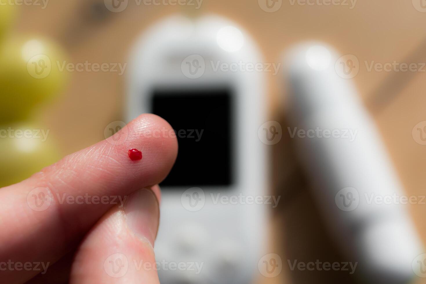 Woman pricking her finger to check blood glucose level with glucometer, test blood glucose for diabetes photo