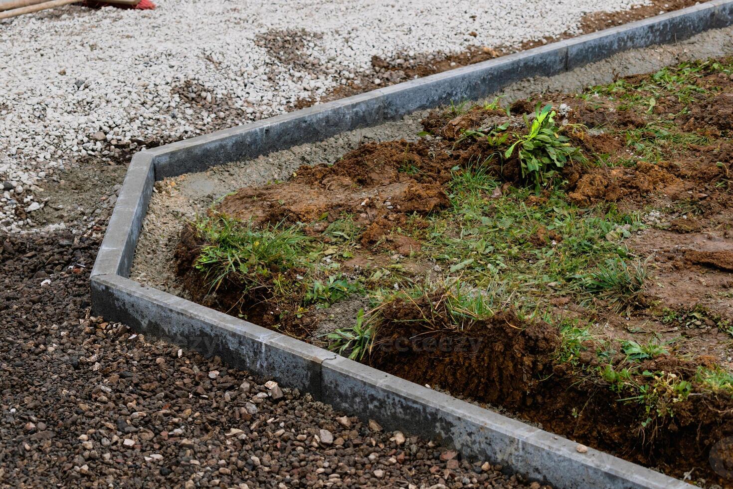 Concrete garden borders with cement to demarcate paths, parkings, sidewalks and flowerbeds photo