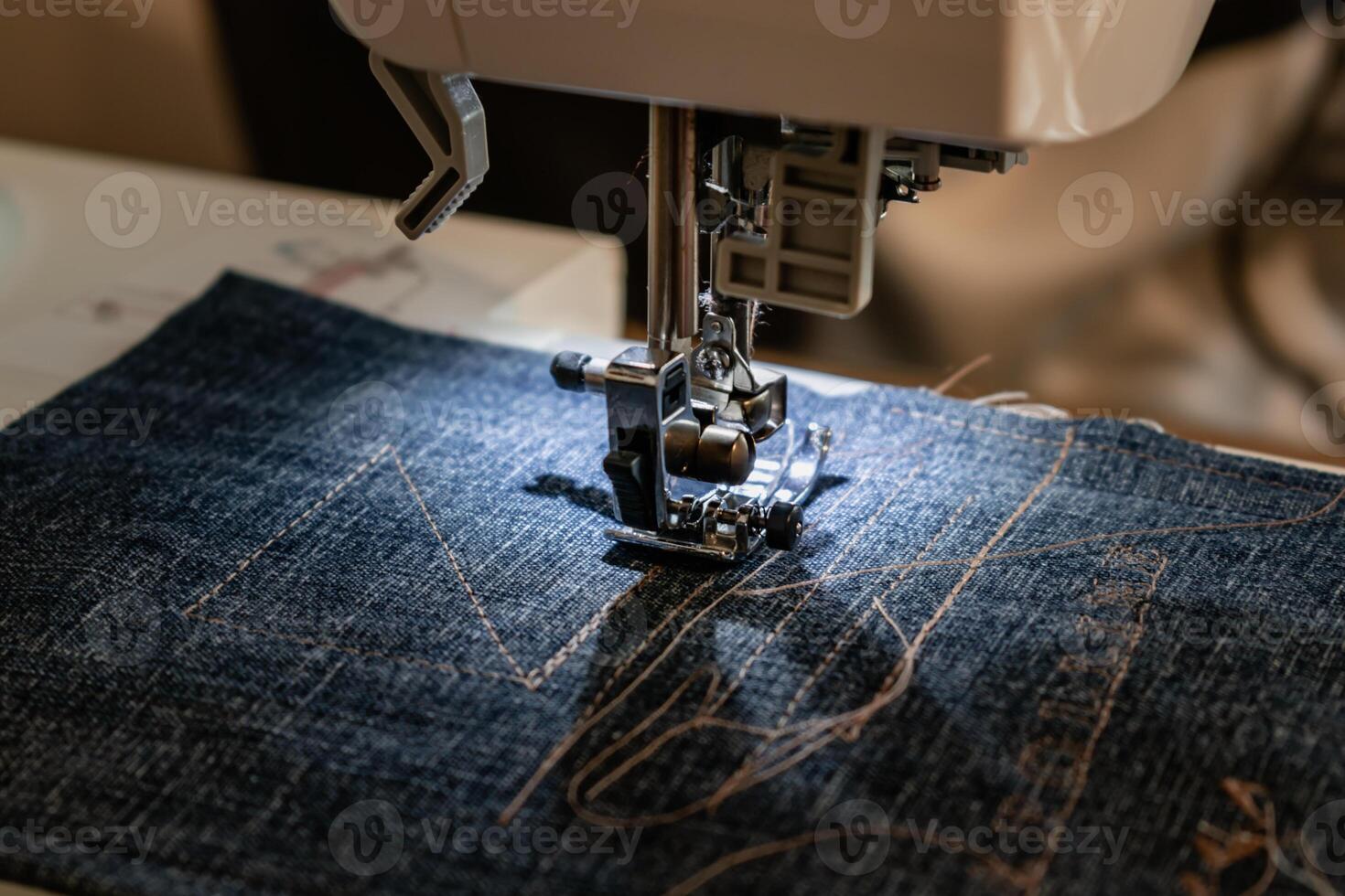 Man using a sewing machine with a blue garment, for repair work, customization, creation, upcycling photo