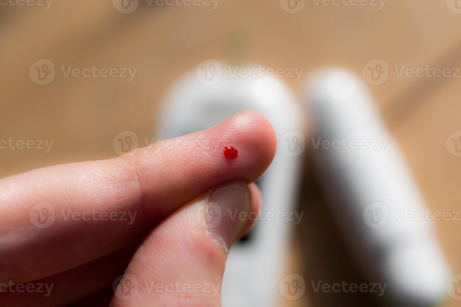 Woman pricking her finger to check blood glucose level with glucometer, test blood glucose for diabetes photo