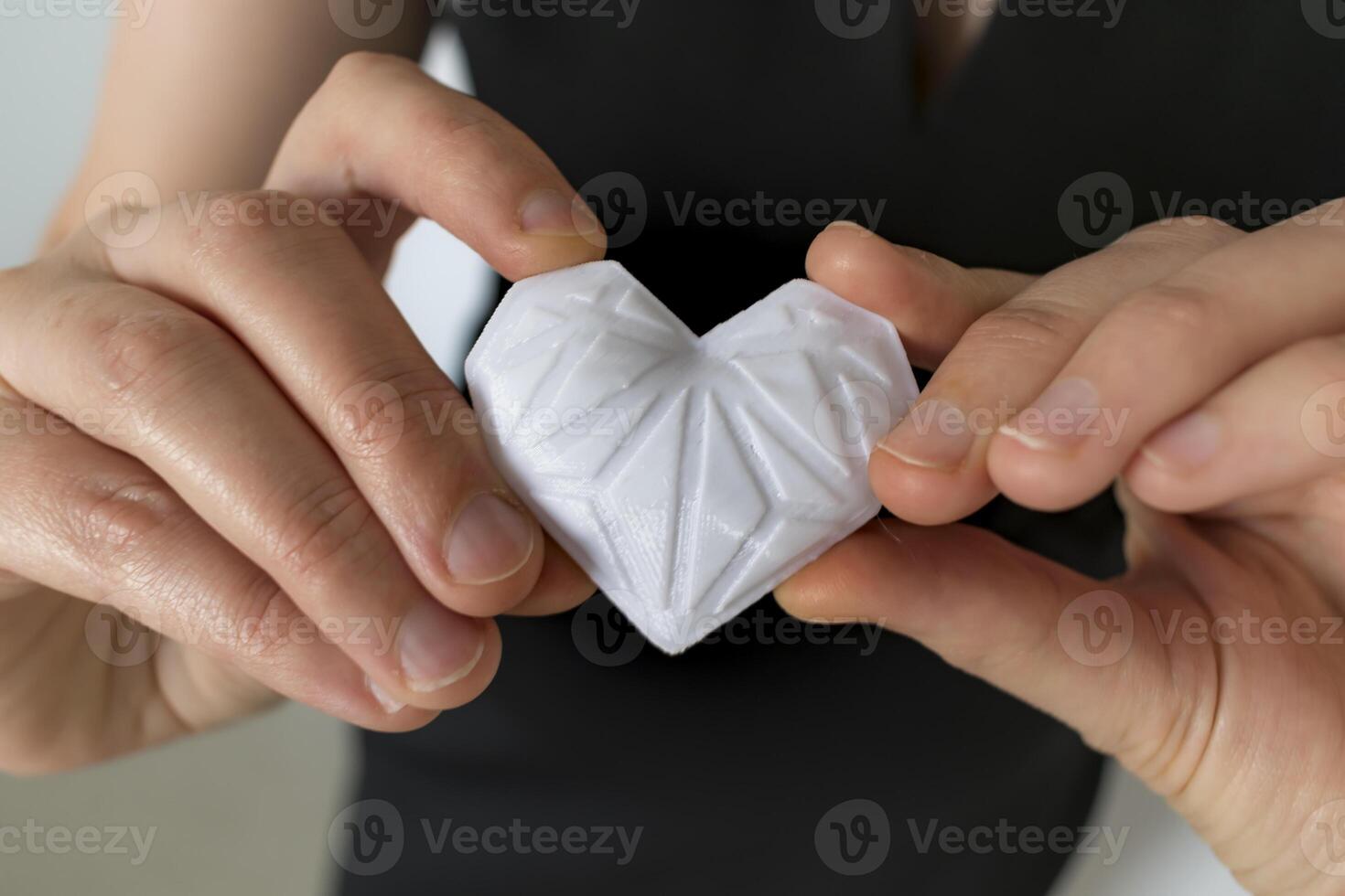 Woman holding white 3d printed heart. Ideal for diverse concept, love and health, gratitude and charity either technology photo