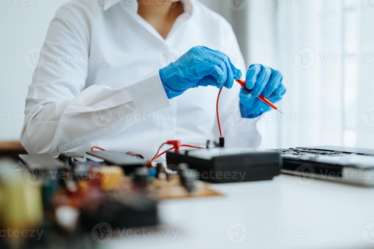 Electronics technician, electronic engineering electronic repair,electronics measuring and testing, repair and maintenance concepts.uses a voltage meter to check and upgrade photo