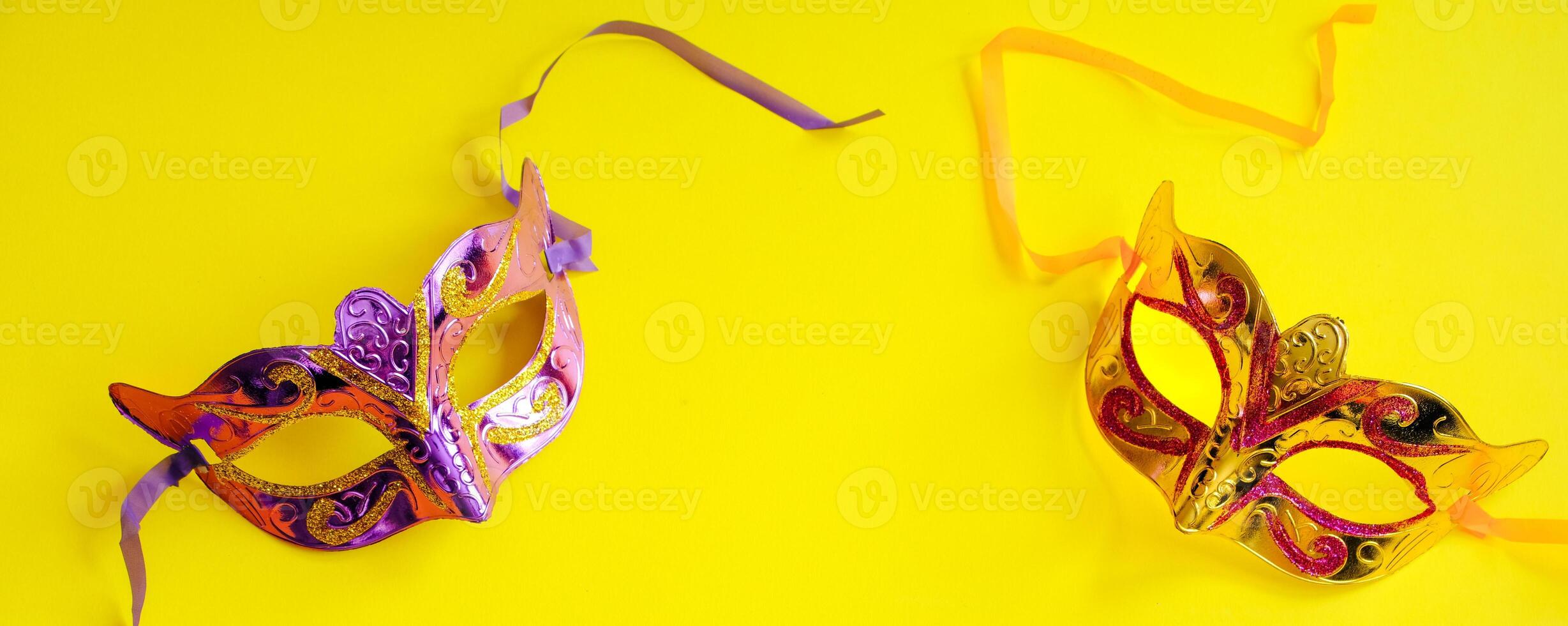 Carnival mask on yellow background. Mardi Gras concept. Fat Tuesday symbol. photo