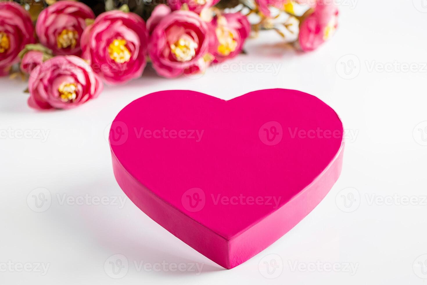 Pink heart for valentines day on a background of flowers. photo