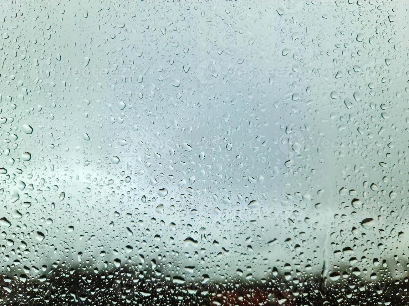 Rain drops running down a window in a close up view. photo