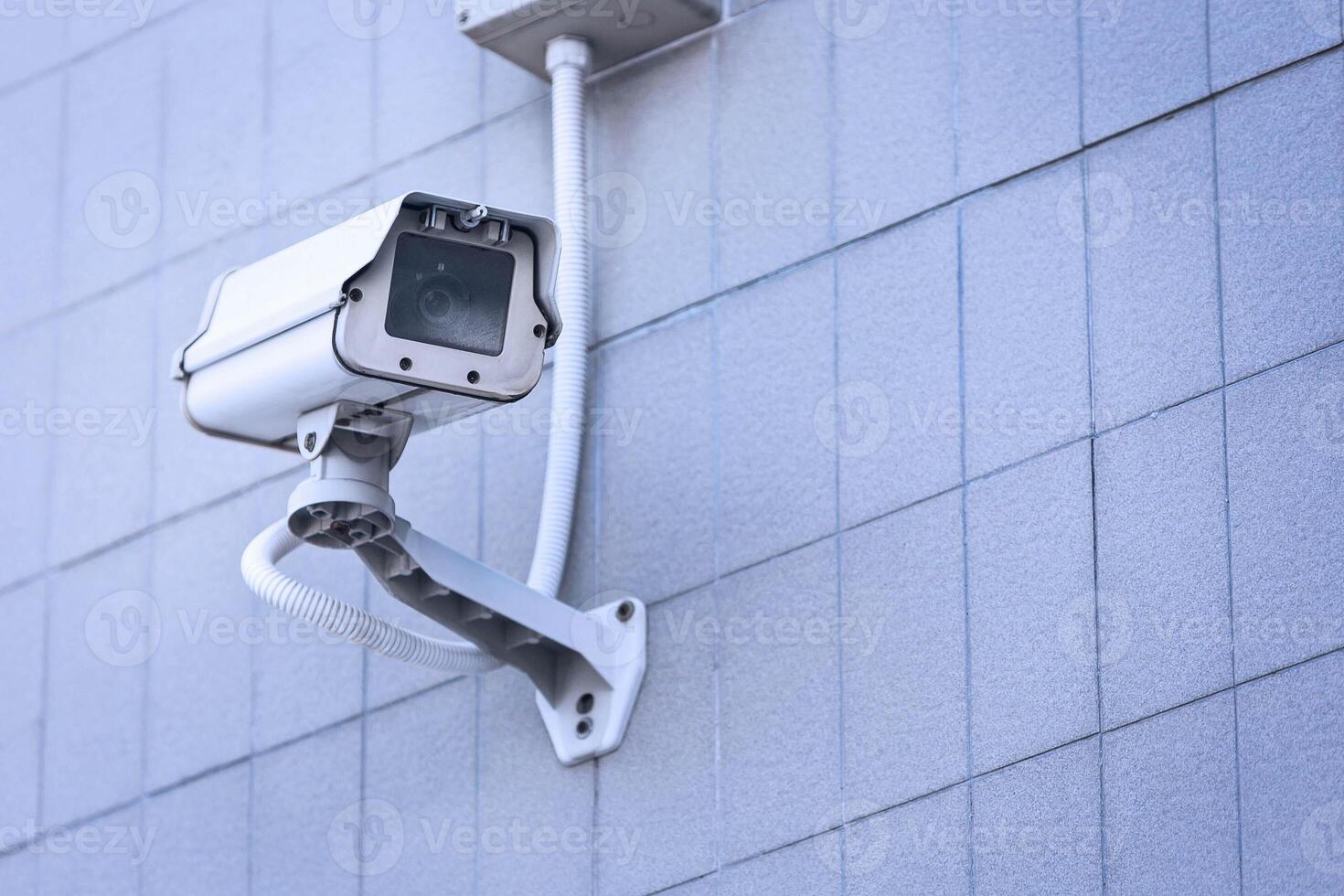 CCTV camera on the wall high building. photo