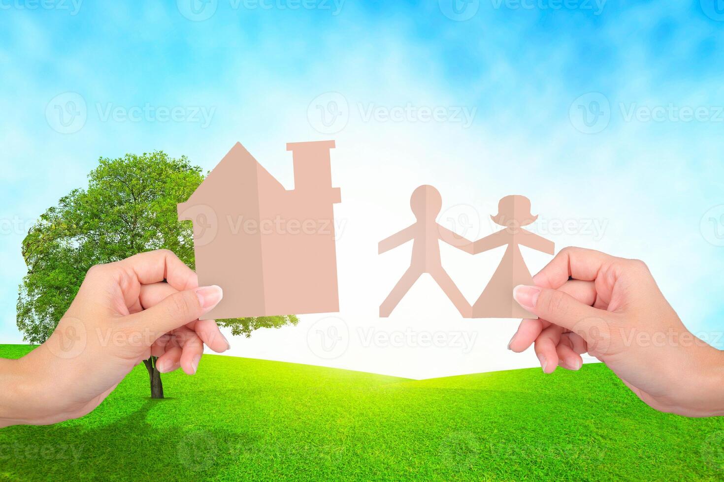 Hands holding family papers on grassland background. photo