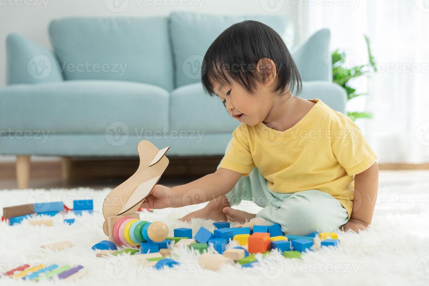 Happy Asian child playing and learning toy blocks. children are very happy and excited at home. child have a great time playing, activities, development, attention deficit hyperactivity disorder photo