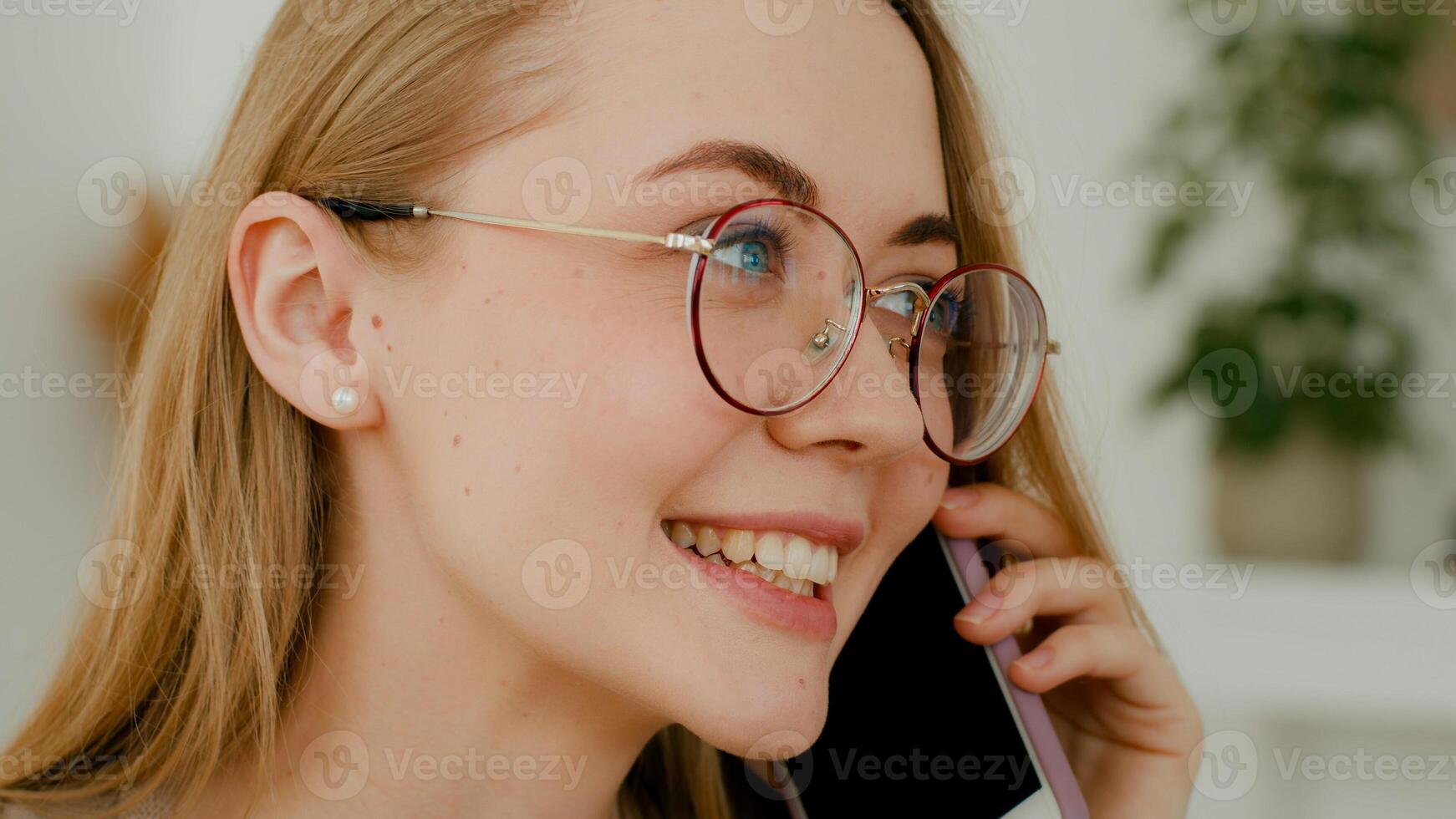 Close up female face smiling businesswoman in glasses answer call. Headshot Caucasian positive woman talking phone with friend share news gossip answering cell communicate girl with smartphone talk photo