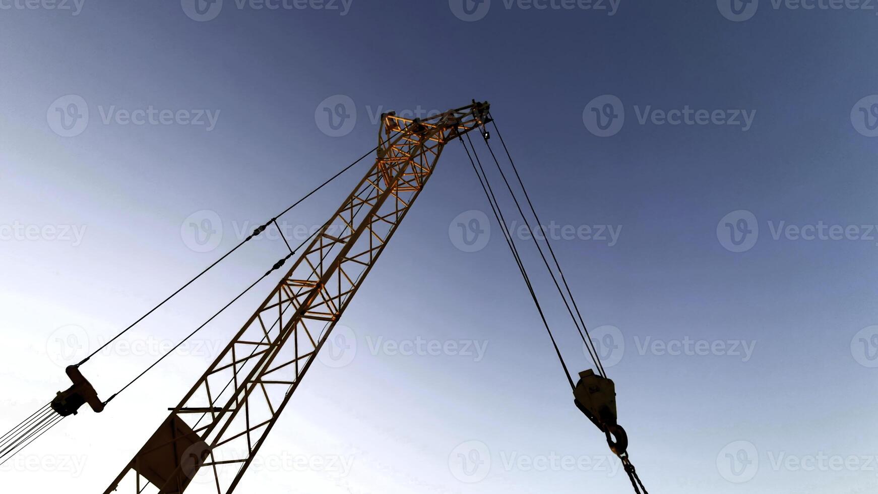 Building crane against the background of clouds. Clip. Tower crane, details of the construction site. photo