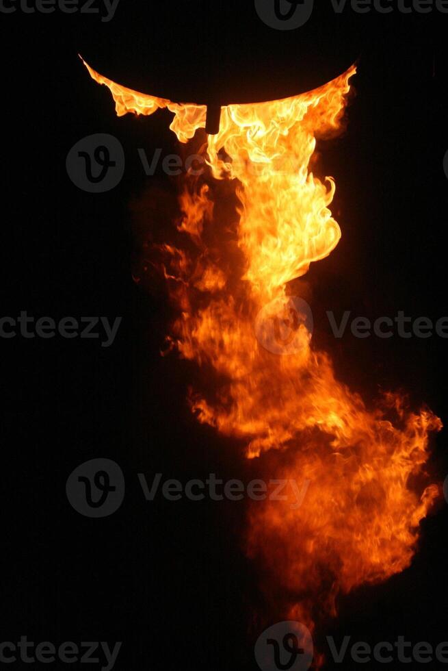 Glowing Blaze Powerful Flaming Torch Illuminating the Dark Night - Dynamic Fire Concept for Design and Creativity Down photo