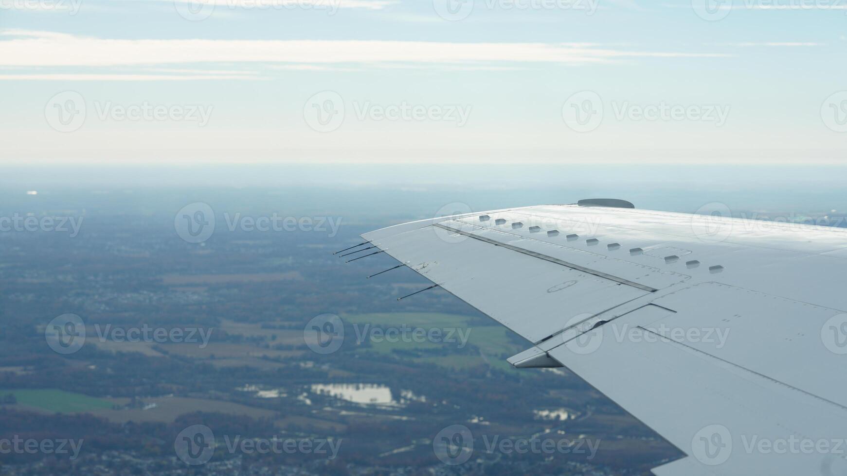 The airplane wing view looked from the flying plane window with the sunset sunlight on it photo