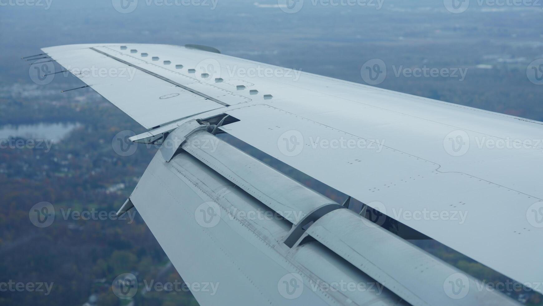 The airplane wing view looked from the flying plane window with the sunset sunlight on it photo